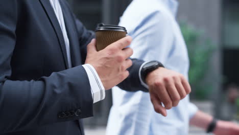 confident businessman walking hold coffee downtown. male hand with cup closeup.