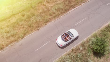 aerial view of a convertible car on a country road