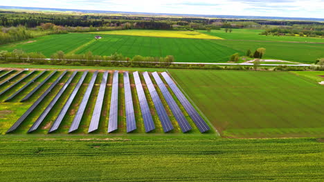 aerial establishing fly solar panel grid aligned in a countryside field, green energy source, renewable system