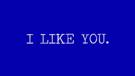 The-changing-text-I-like---miss---want---love-you,-white-characters-on-a-blue-background,-typewriter-font