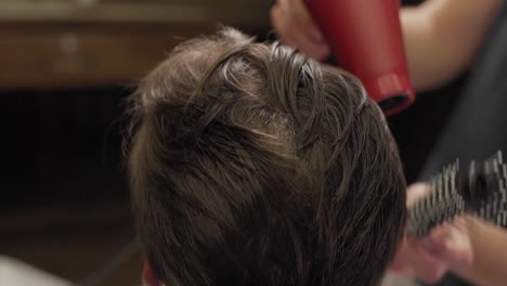 close-up-of-a-man's-hair-styling-with-a-brush-brush