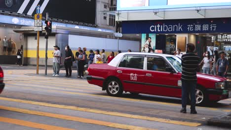 pedestrians and vehicles at a bustling intersection