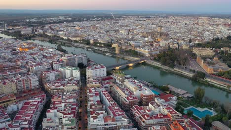 aerial view of seville spanish capital city, spain cityscape drone shot with the guadalquivir river in andalusia