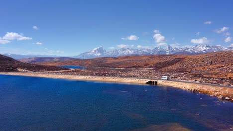 scenic drive on coastal road with scenery of ge'nyen massif in litang county, china