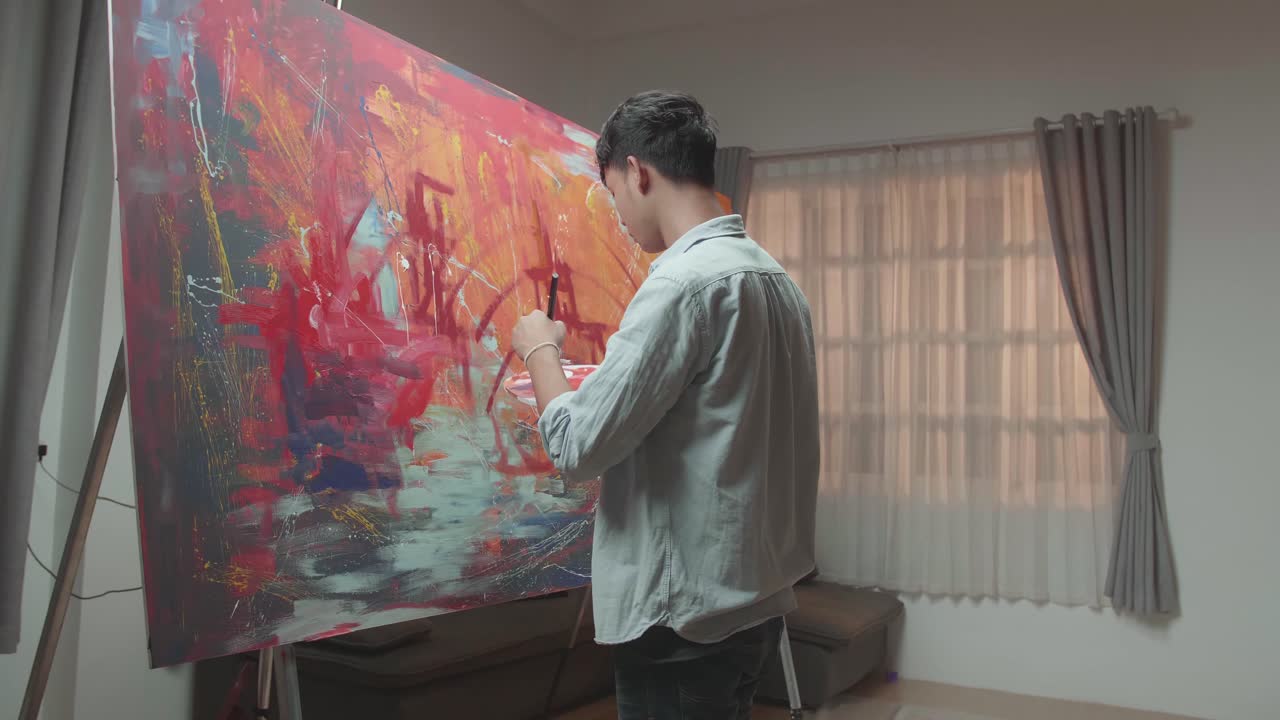 Asian Male Artist Working On Abstract Painting