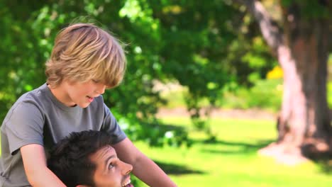 Young-boy-having-fun-on-his-fathers-shoulders