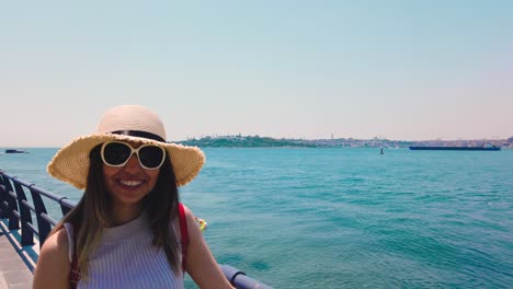 Slow-Motion:beautiful-girl-shows-Bosphorus-and-Maidens-Tower,a-popular-destination-in-Istanbul,Turkey