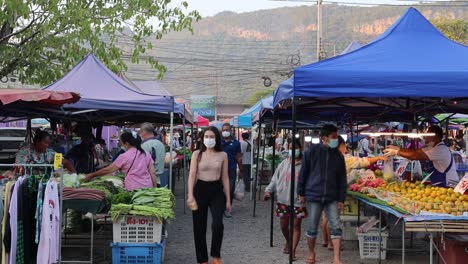 shoppers navigate through a busy market