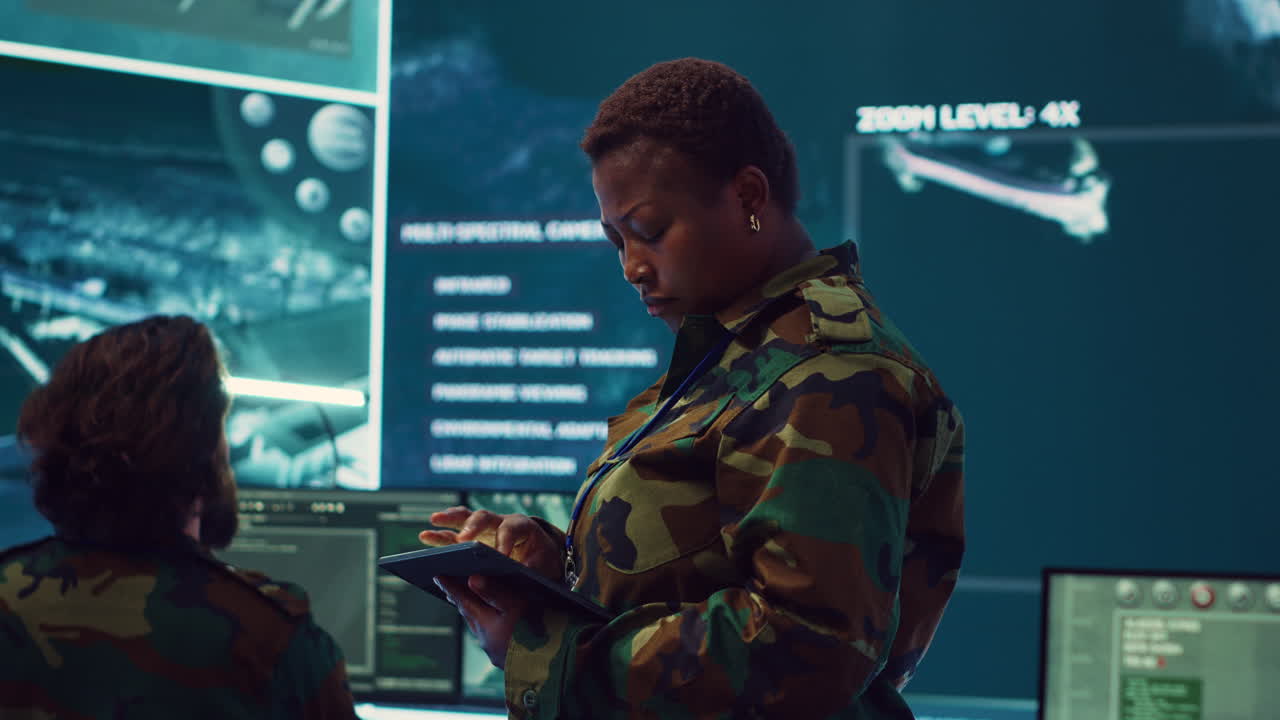 Woman high tech specialist studying satellite CCTV visualization on a big screen