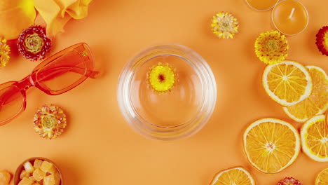 orange aesthetic still life with flowers and citrus