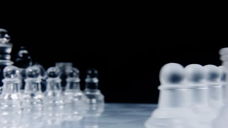 a wonderful chessboard, with two different full sets of chess pieces made of glass, starting to spin and moderately accelerating, showing both factions ready to fight