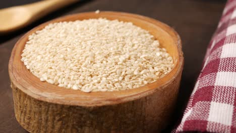 white sesame seeds in wooden bowl