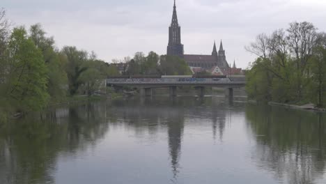 the danube river reflects the famous landmark of ulm, the ulm minster cathedral