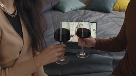 couple enjoying a video call with wine