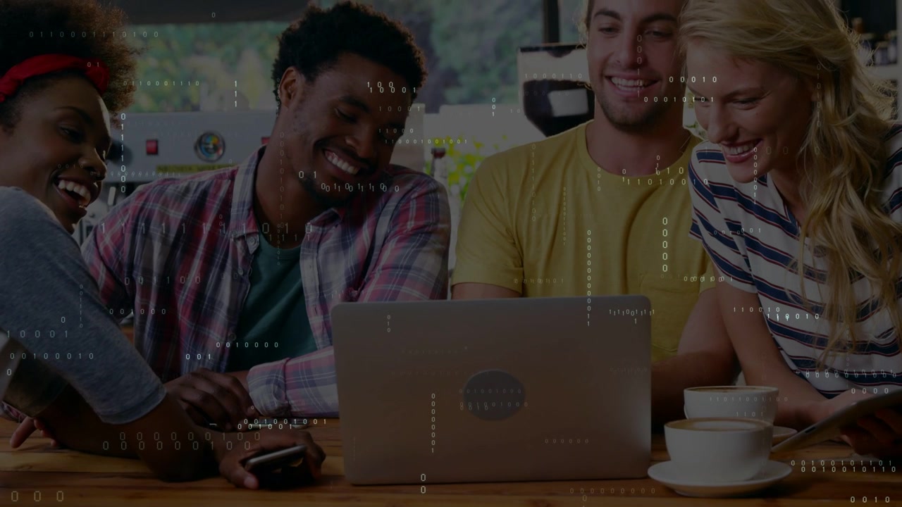 Group of four adults leaning toward laptop with ping popping pointing and sharing phone for review