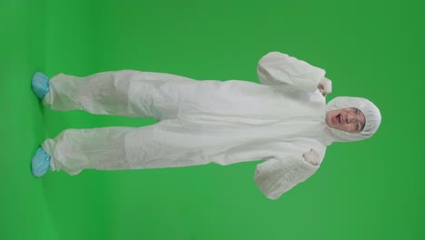 full body of asian man wearing personal protective equipment uniform ppe and celebrating in the green screen studio