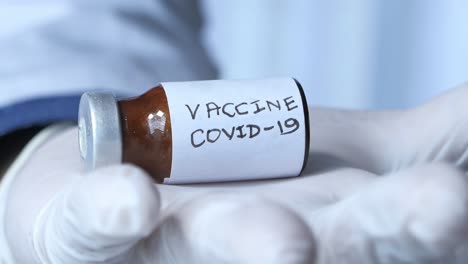 doctor holding a covid-19 vaccine