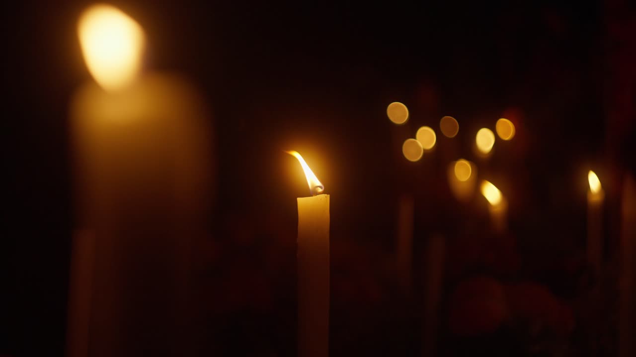 Candle lit at night for All Saints' Day. Close up