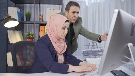 team work. muslim business woman and her male colleague work in the office.