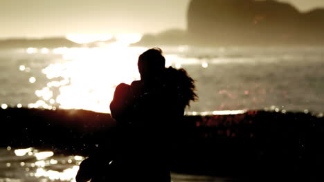 woman jumping in the arms of boyfriend on the evening