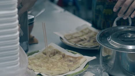 man-in-apron-sticks-wooden-wands-in-delicious-pastry