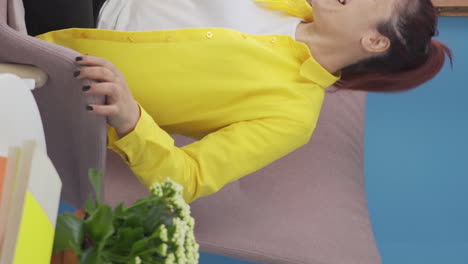 Vertical-video-of-Happy-woman-lying-on-the-sofa.-She-is-resting.