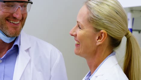 Male-and-female-dentist-interacting-with-each-other