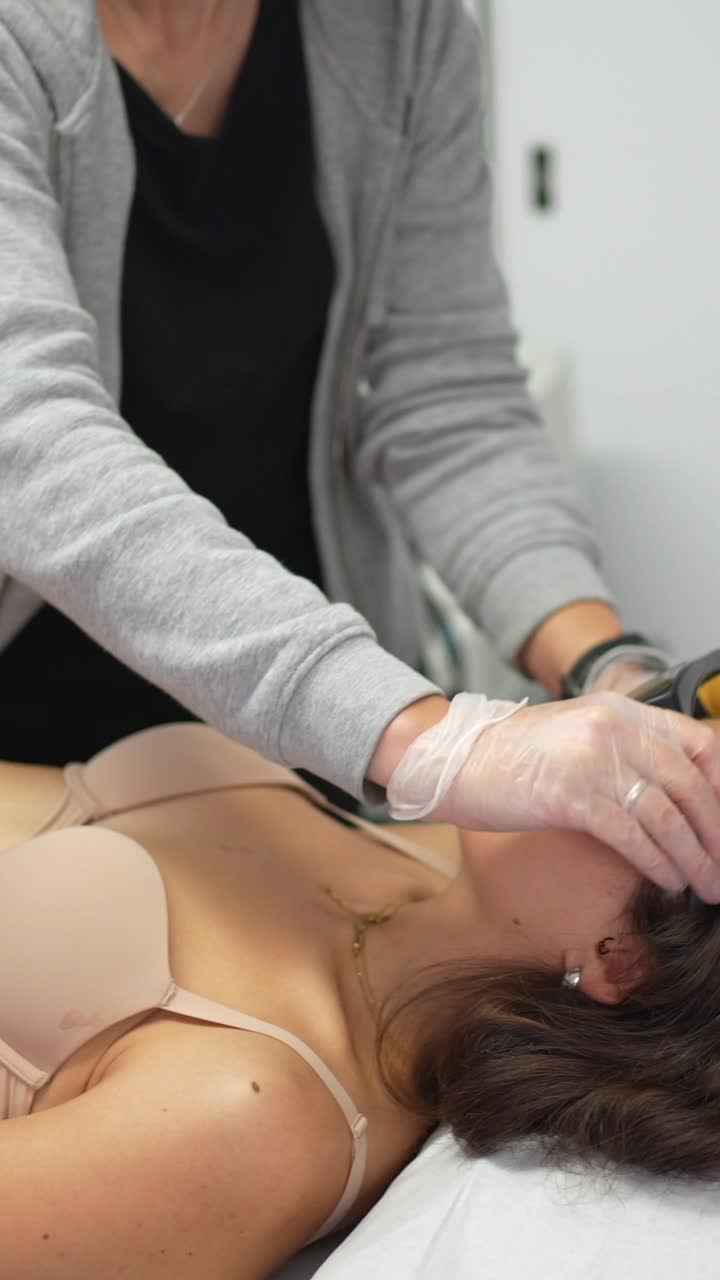 Woman receiving laser treatment in a clinic
