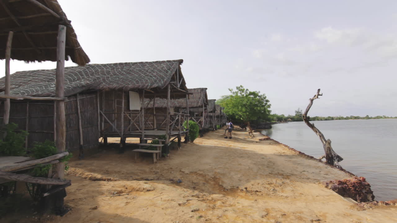 Local town shack houses with tourists waiting at Senegal Africa