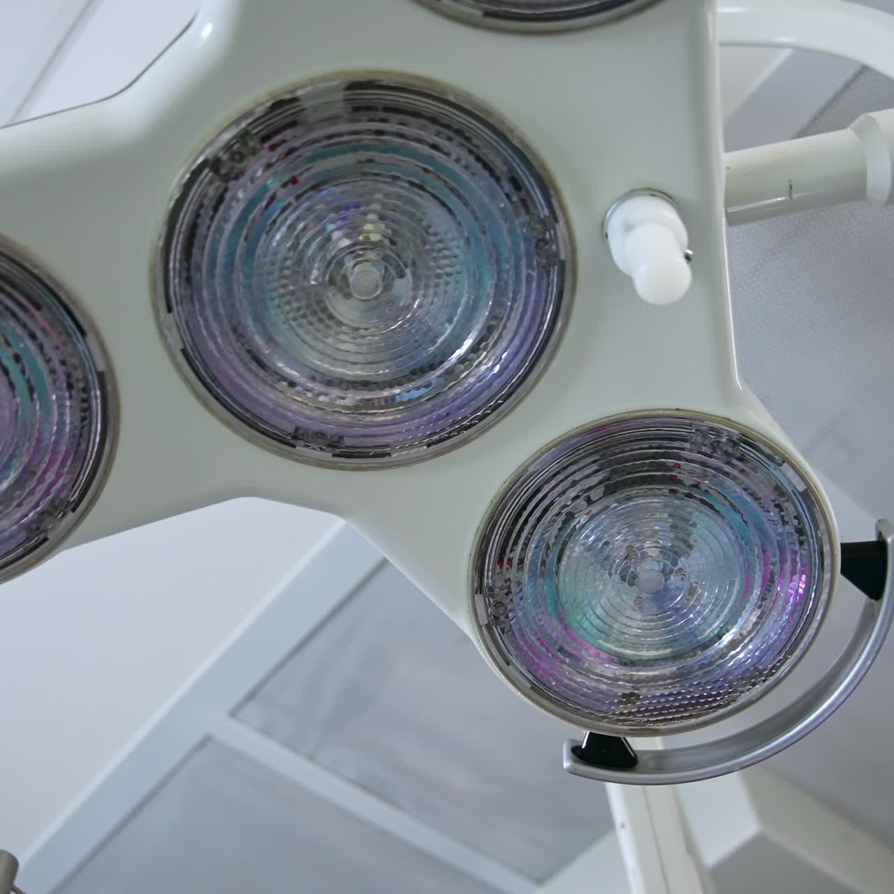 Switched off lamp in the surgical room. Low angle view. Close up look at the modern illumination equipment in operational theatre