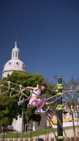 woman exercising on outdoor workout equipment in a city park