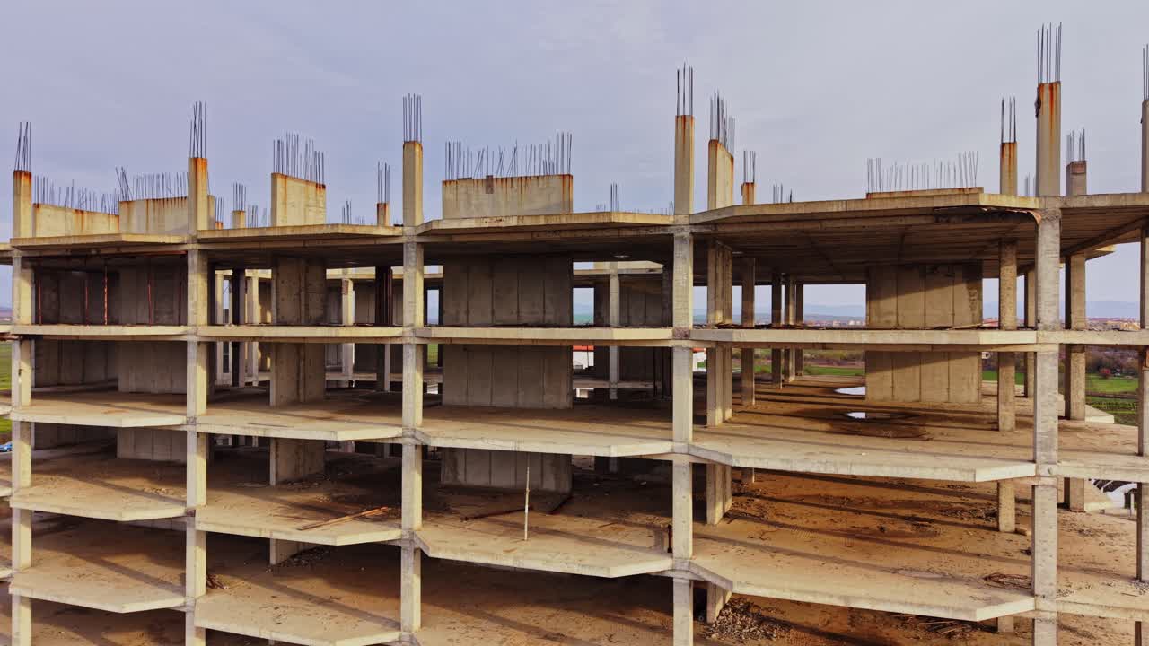 Construction site aerial view of a partially built structure with rebar