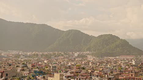 aerial view of kathmandu city cityscape in nepal, beautiful light view of kathmandu city and kathmandu valley mountain scenery with houses and buildings and sunrise morning golden orange sunlight