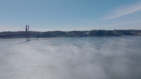 drone shot of the fog over the river tejo, in lisbon.
