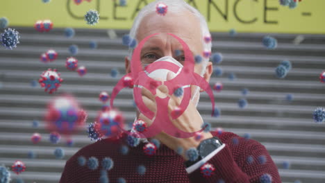 animation of covid 19 cells over senior man wearing face mask