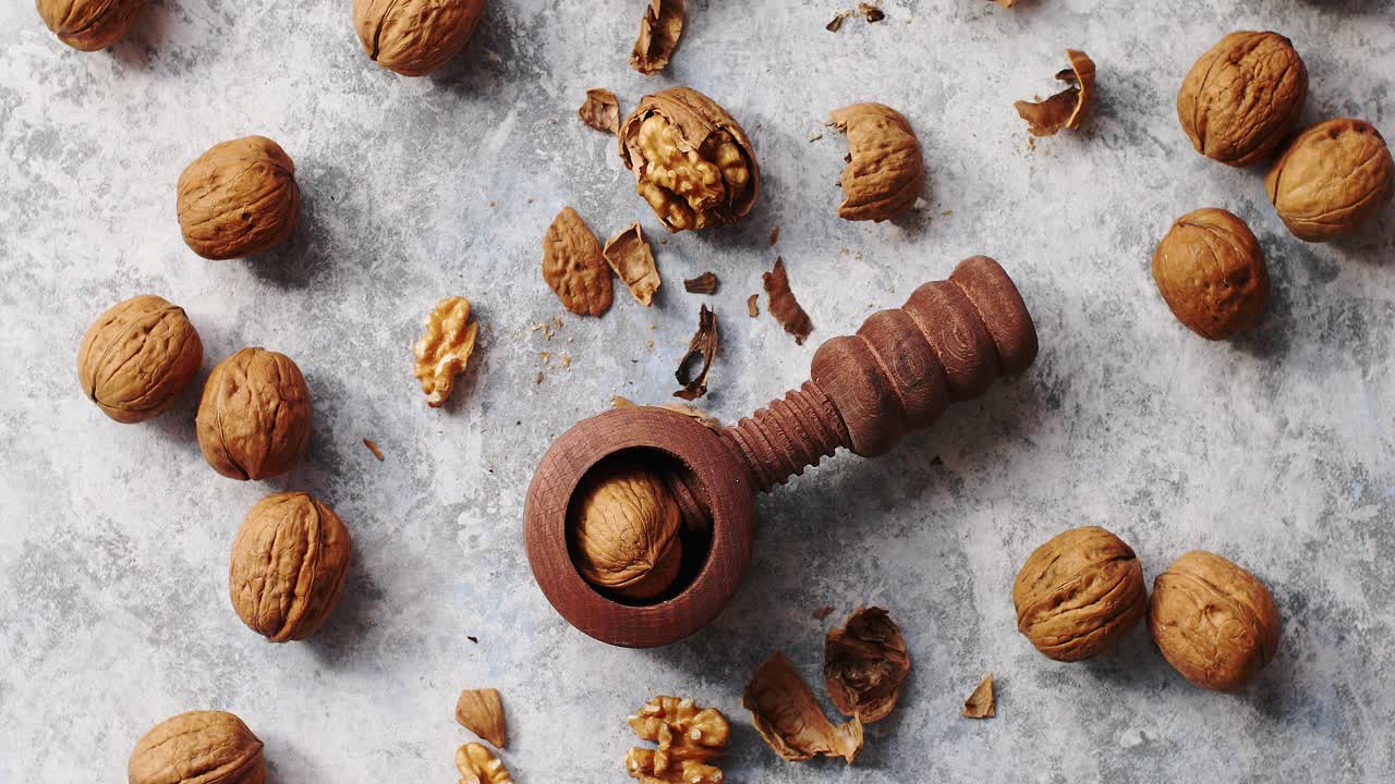 Wooden cracker with walnuts in composition