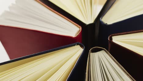 video of composition with diverse books standing on brown surface