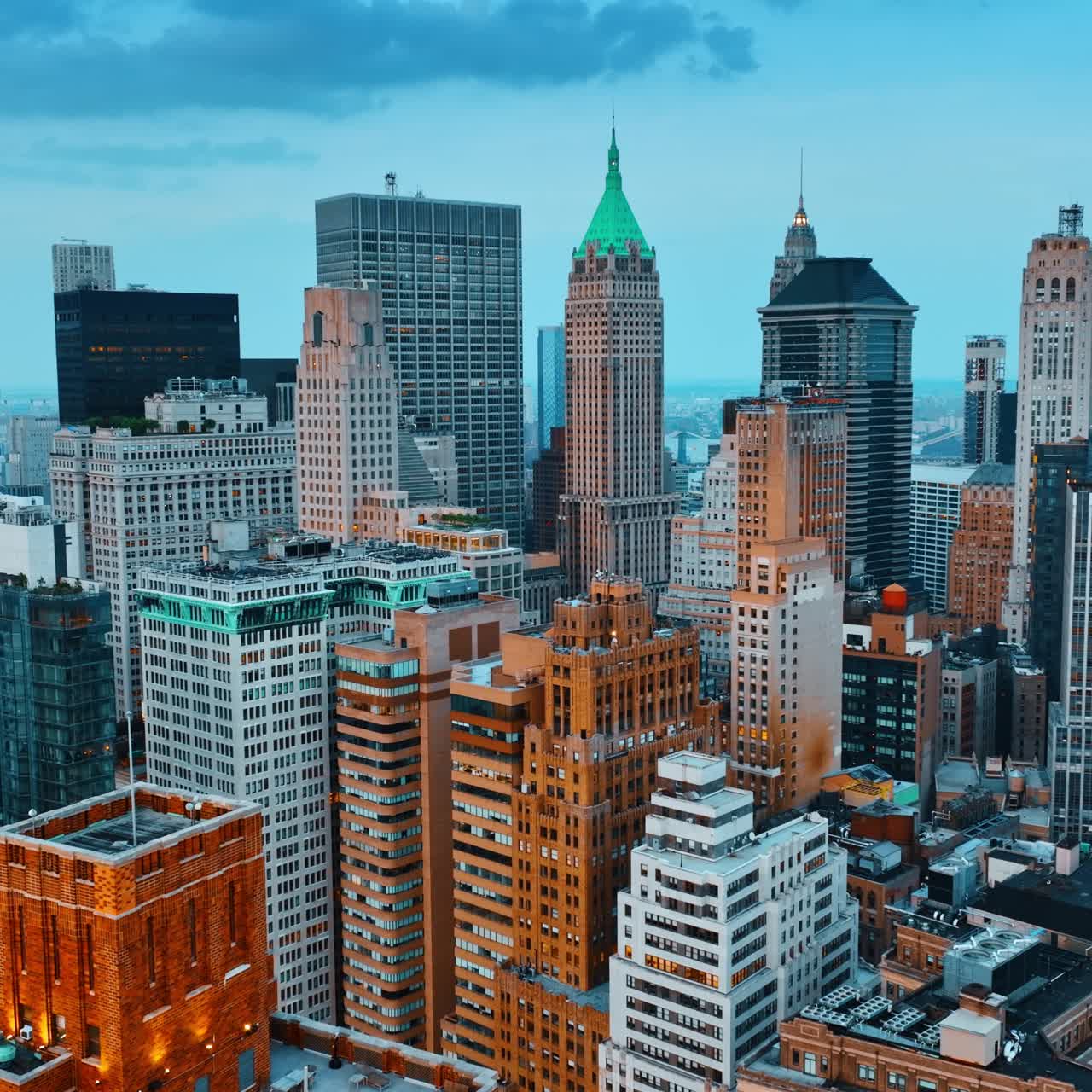 Wonderful skyscrapers built close to each other. Drone footage approaching famous buildings tops at dusk