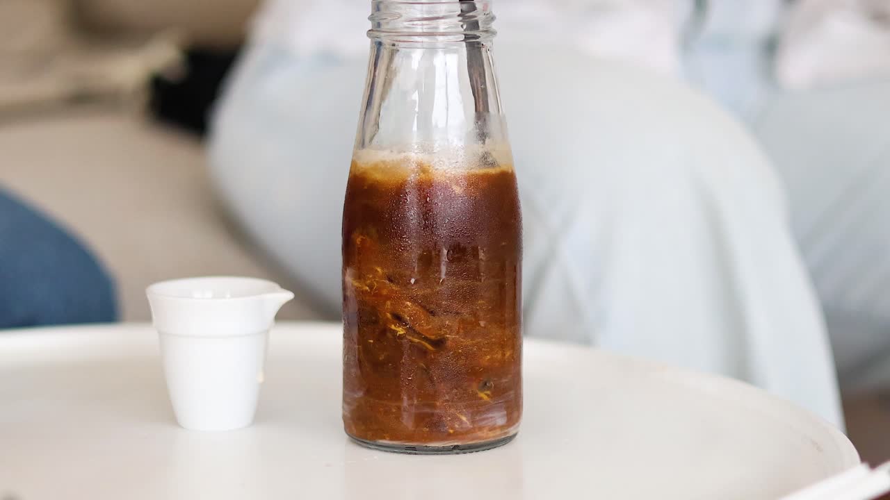 secuencia de verter café de la botella a la taza