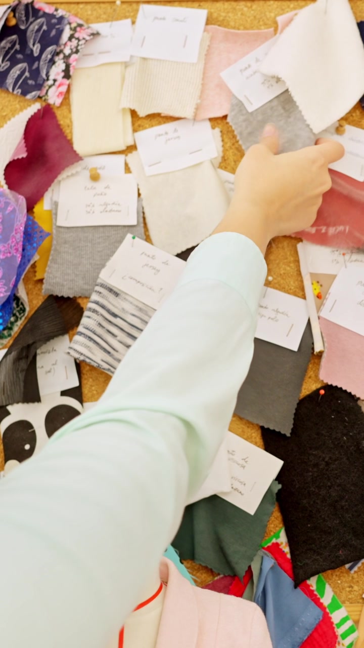 Fashion designer choosing textile swatches on a mood board