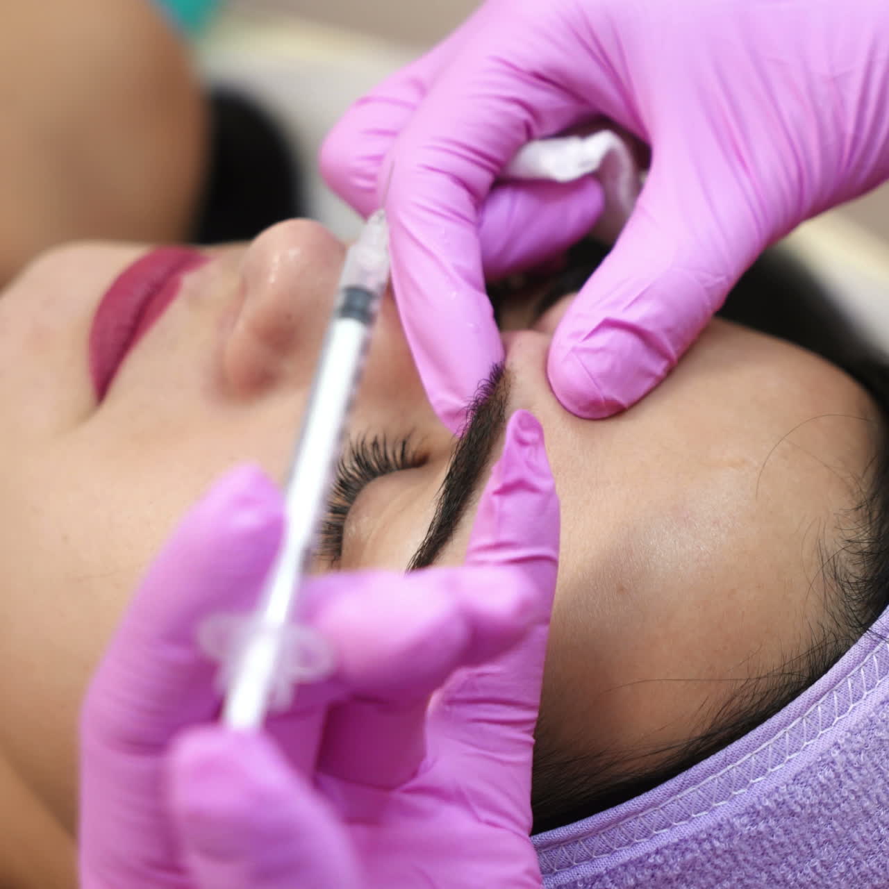 The young beautiful woman in a spa receiving facial treatment injections. Face aging, rejuvenation and hydration procedures. Aesthetic cosmetology.