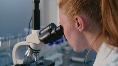 scientist using microscope