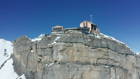 aerial jib of ski lift building at the top of snowy mountain