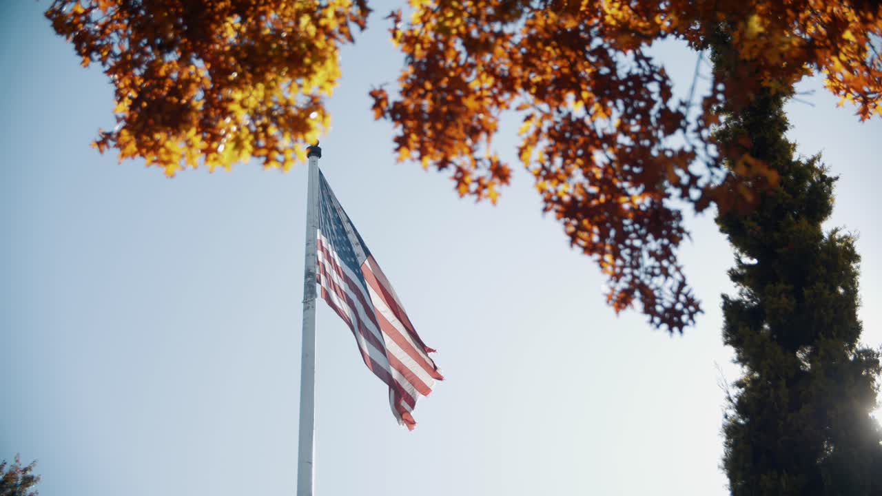 4k slow motion footage of american flag waving in the wind in fall and golden light in the morning - USA - United States - Portland Oregon
