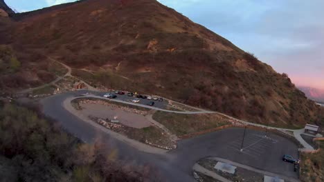 Parking-lot-with-trail-and-cliffs-in-background-near-Provo,-Utah-in-pink-sky