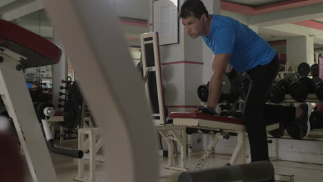 at the gym young man doing exercise for triceps