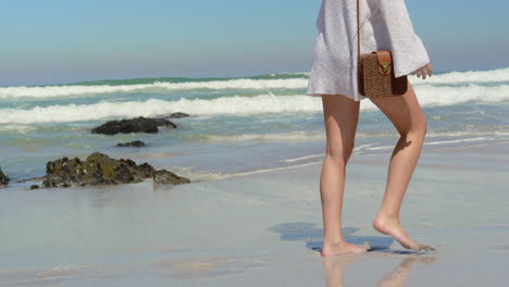 young woman walking at beach 4k