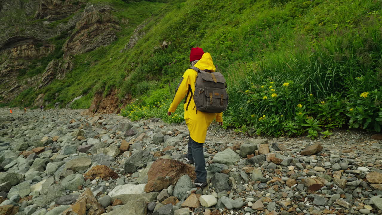 Person Hiking on a Rocky Coastline