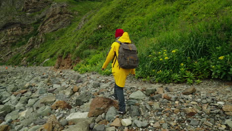 person hiking on a rocky coastline
