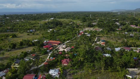 aerial drone fly above cebu island rural village in philippines southeast asia travel destination in summer, skyline with ocean, agricultural fields